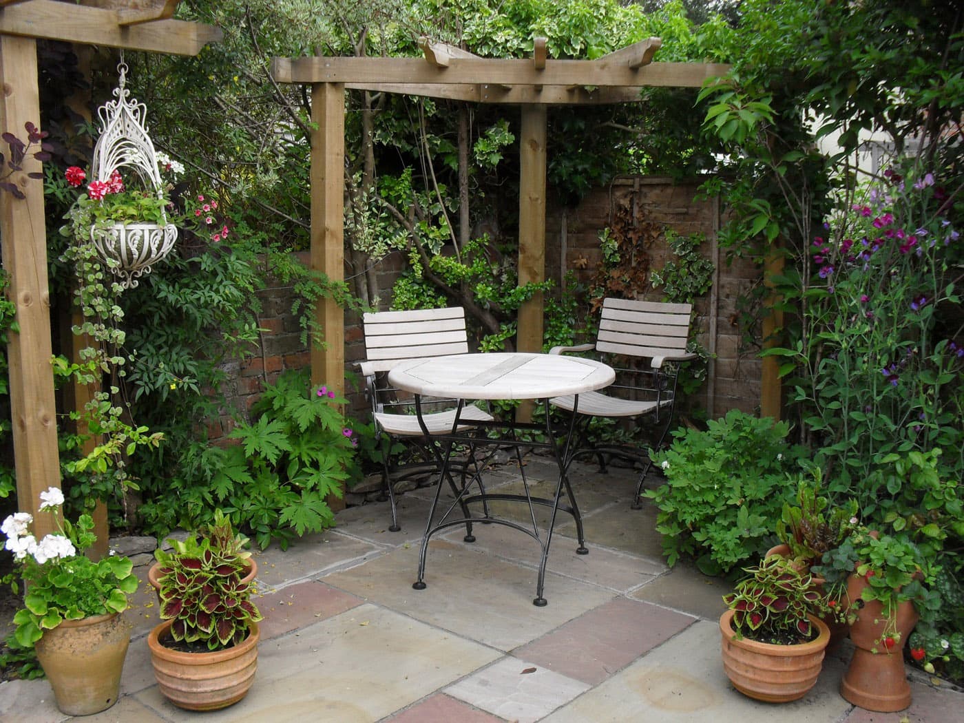 Pergola-covered garden patio with a bistro table built by Holt Landscape in Rocklin, CA