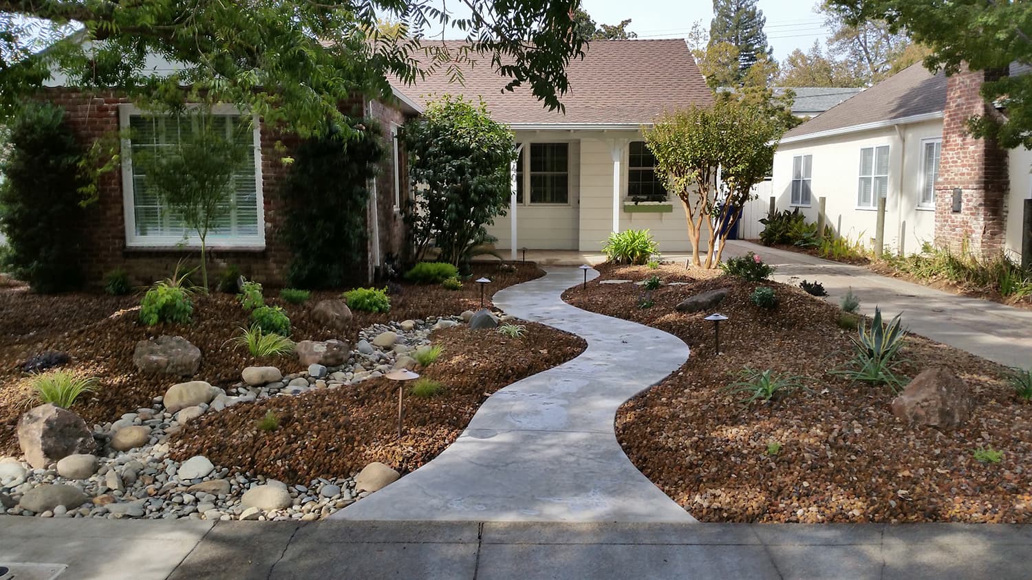 Front yard dry creek bed and walkway at a craftsman bungalow