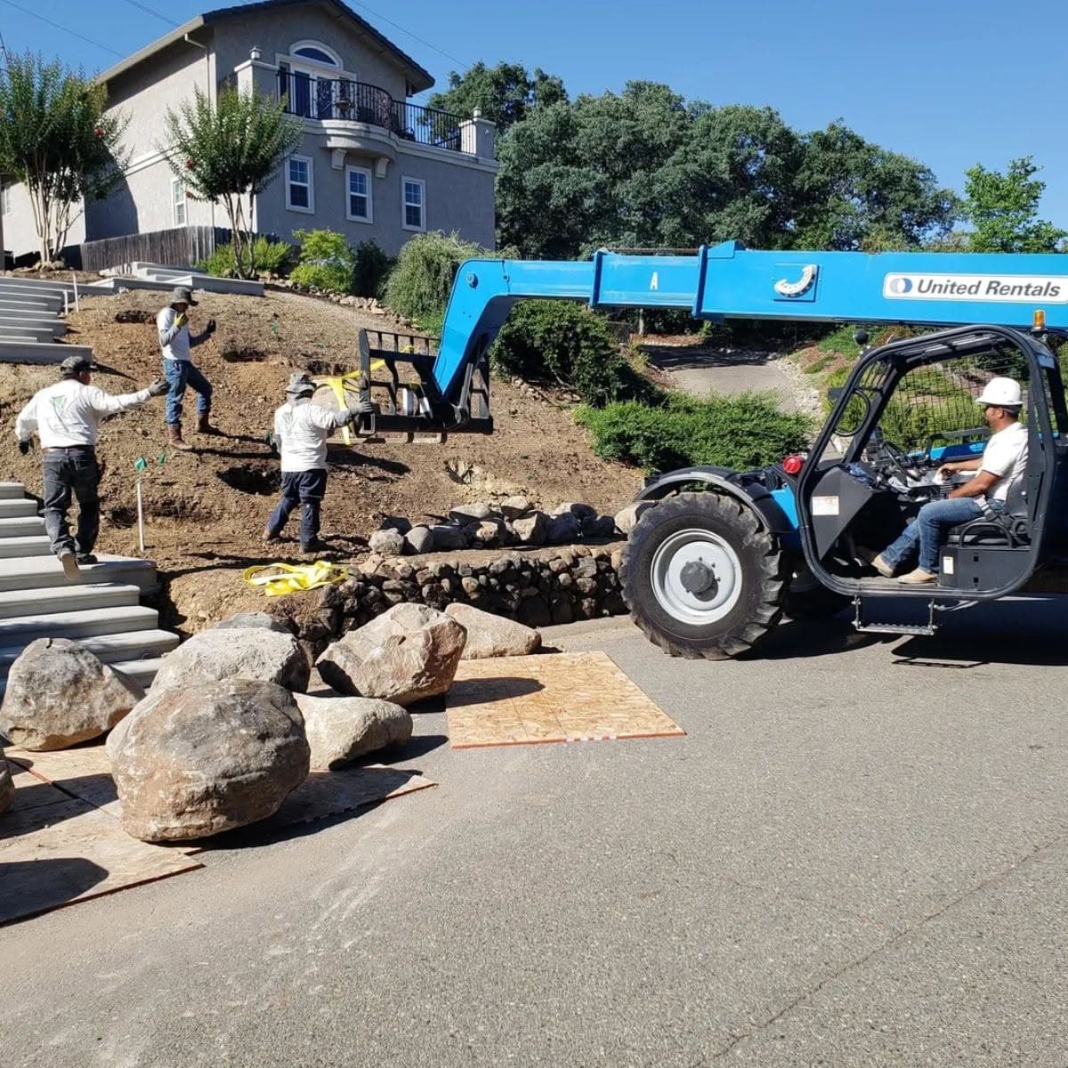 Holt Landscape crew installing a boulder retaining wall for a project in Lincoln, CA