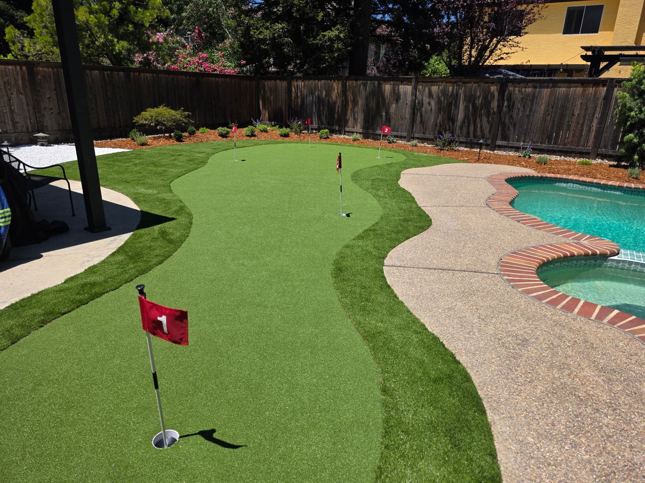 Backyard putting green and artificial turf landscape installed by Holt Landscape near Loomis, CA